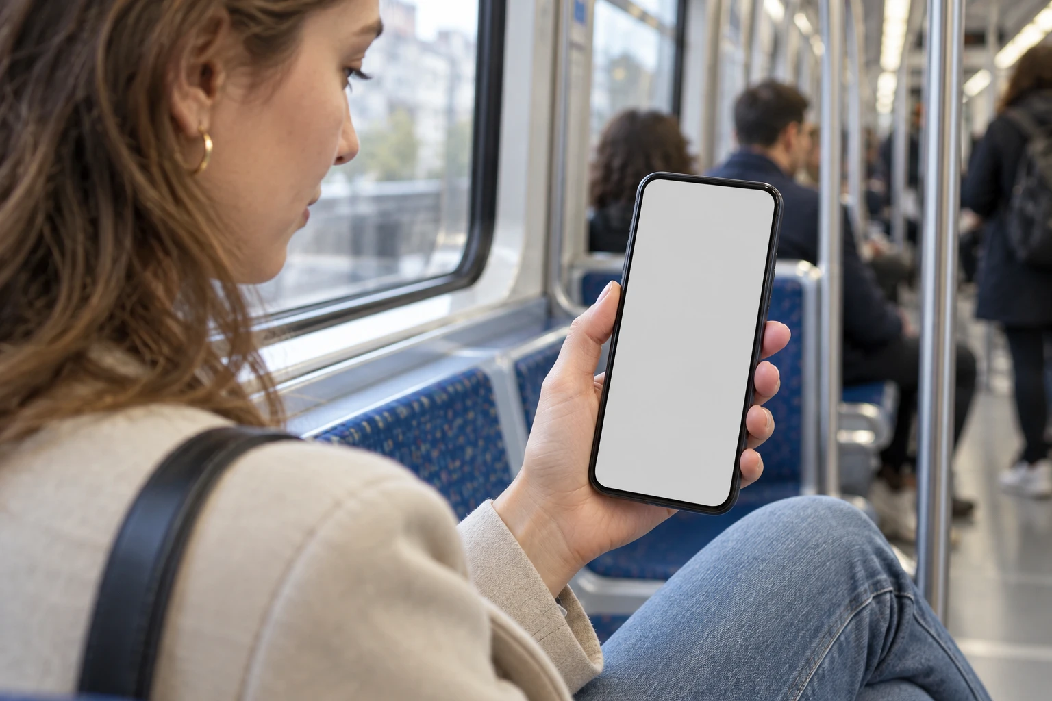 Une personne en tenue de ville consulte BlocPocket sur son téléphone dans le métro.